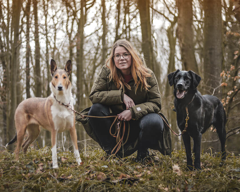 Eine Frau in der Bildmitte und zwei Hunde.